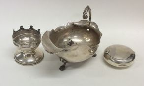 A silver sauce boat together with a tobacco pouch