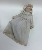 A German porcelain headed miniature doll. Est. £25