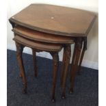 A nest of three burr walnut table with drop flaps.