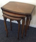 A nest of three burr walnut table with drop flaps.