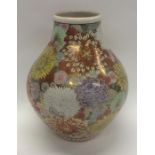 A massive Japanese gilt vase decorated with bright