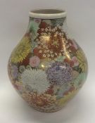 A massive Japanese gilt vase decorated with bright