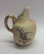 A Royal Worcester ewer decorated with flowers and