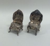 A pair of silver doll's house floral decorated chai