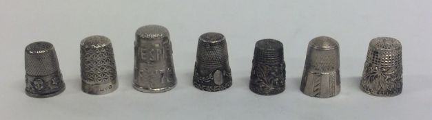 A bag containing seven silver thimbles. Approx. 36