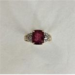 A diamond and ruby cluster ring in claw mount. App