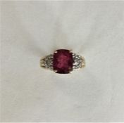 A diamond and ruby cluster ring in claw mount. App