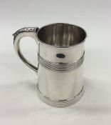 A Georgian silver tapering mug with reeded decorat