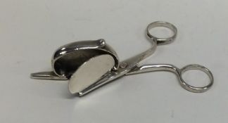 A pair of early silver candle snuffers with hinged