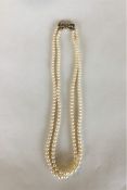 A graduated double string of pearl beads with conc