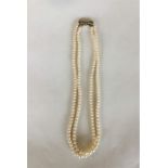 A graduated double string of pearl beads with conc