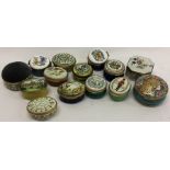 A large collection of oval pottery pill boxes. Est