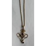 A 9 carat garnet set pendant on fine link chain. A