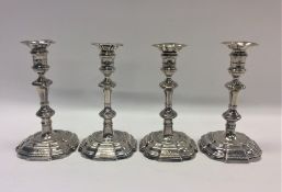 A rare set of four Georgian silver cast candlestic