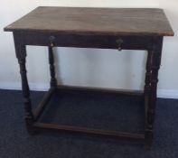 An Antique plank top single drawer side table on t