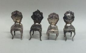 A good set of four silver dining chairs decorated