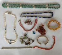 A box containing beads, silver bracelet etc. Est.