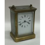 A small brass mounted carriage clock with white en