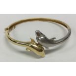 A stylish 14 carat two coloured gold bangle decora