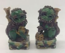 A pair of decorative figures of Dogs of Foo. Est.