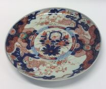 An Imari circular charger decorated with bright co