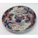 An Imari circular charger decorated with bright co
