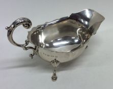 An Edwardian silver sauce boat with card cut rim.