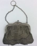 A Continental silver mesh purse on suspension chai