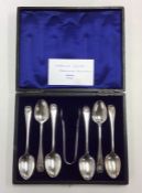 A boxed set of six Edwardian silver teaspoons deco