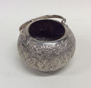 A large circular silver cylindrical caddy with swi