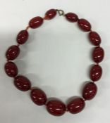 A graduated string of red amber beads. Approx. 80