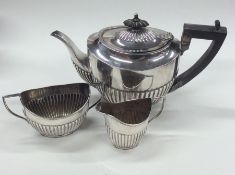 A silver three piece half fluted tea set. Birmingh