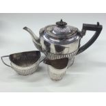 A silver three piece half fluted tea set. Birmingh