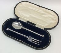 A cased silver nail top two piece christening set.