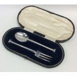 A cased silver nail top two piece christening set.