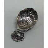 A modern silver cast caddy spoon with fluted bowl.