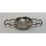 An early Georgian silver two handled lemon straine