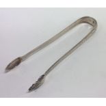 A good pair of Irish silver bright cut sugar tongs