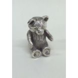 A miniature cast silver model of a teddy bear. Lon