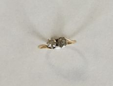 An 18 carat diamond two stone crossover ring. Appr