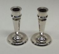 A pair of heavy cast silver Danish candlesticks of