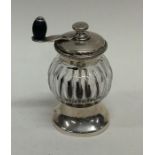 A silver and cut glass pepper grinder with rope tw