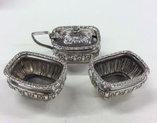 A silver three piece half fluted cruet set. Approx