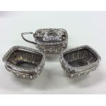 A silver three piece half fluted cruet set. Approx