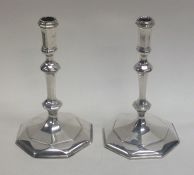 A heavy pair of Edwardian cast silver taper candle