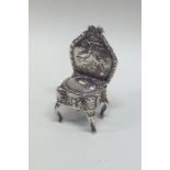 An attractive miniature silver chair decorated wit