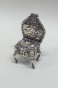 An attractive miniature silver chair decorated wit