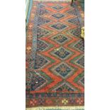 An Antique tapestry Oriental rug in bright colours