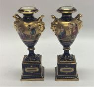 A pair of attractive Vienna vases on square pedest