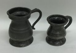 Two pewter miniature baluster shaped tankards. Est